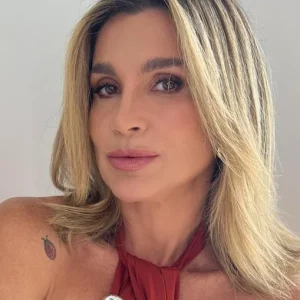 Flávia Alessandra arranca elogios em dia de sol na praia do Rio com biquíni branco e milho verde