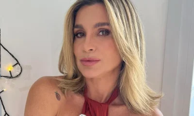 Flávia Alessandra arranca elogios em dia de sol na praia do Rio com biquíni branco e milho verde