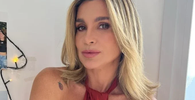 Flávia Alessandra arranca elogios em dia de sol na praia do Rio com biquíni branco e milho verde